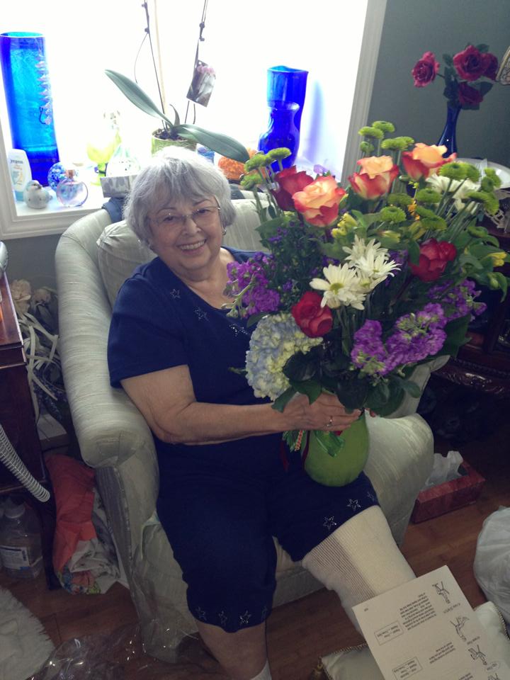 Janet with flowers after knee surgery